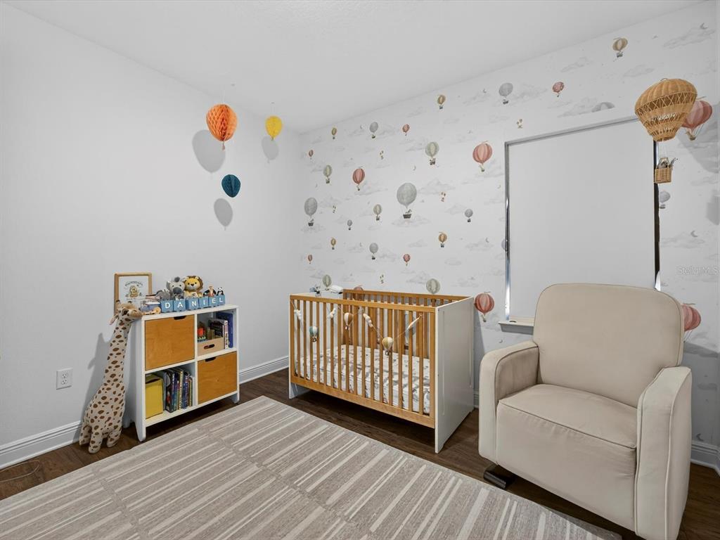 9952 Rodbell Street Orlando, FL 32827 - Photo 27 of 44 a bedroom with furniture and a window