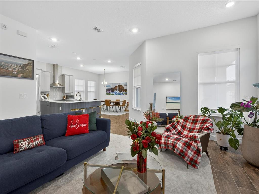 9952 Rodbell Street Orlando, FL 32827 - Photo 4 of 44 a living room with furniture and a potted plant