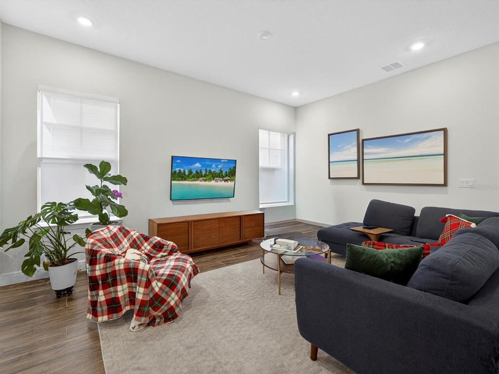 9952 Rodbell Street Orlando, FL 32827 - Photo 6 of 44 a living room with furniture and a potted plant