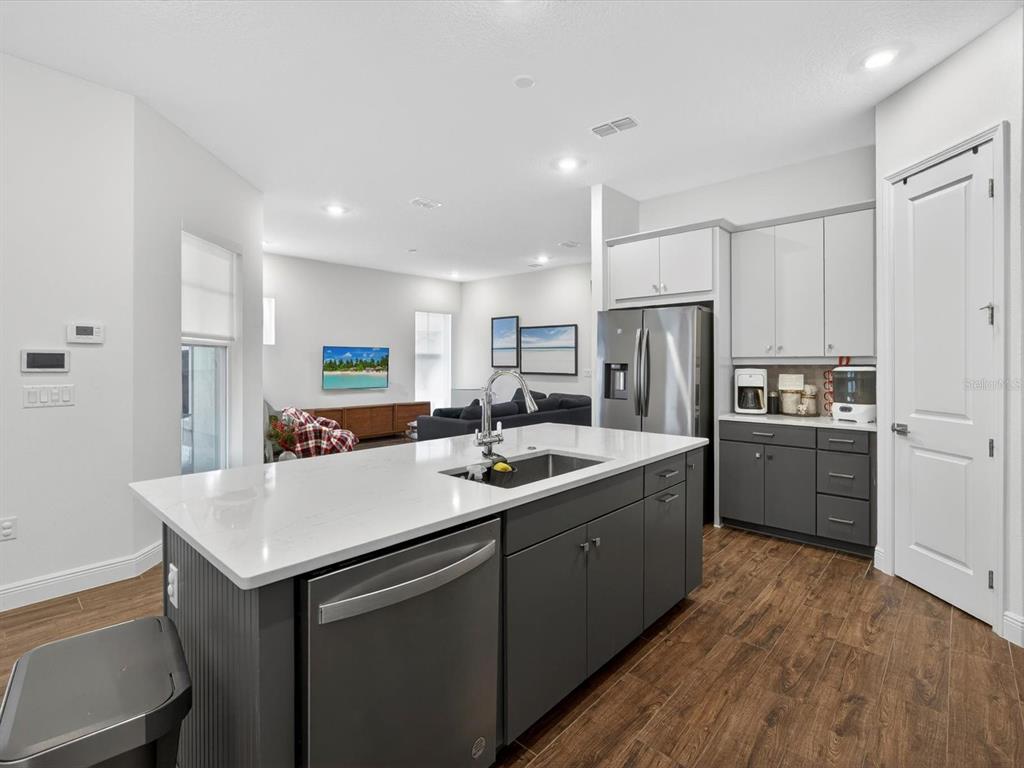 9952 Rodbell Street Orlando, FL 32827 - Photo 9 of 44 a kitchen with kitchen island a sink appliances and cabinets