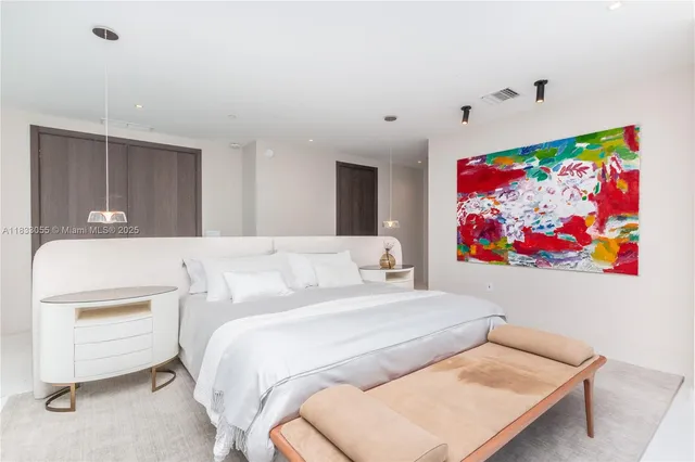 a bedroom with a bed and a large window