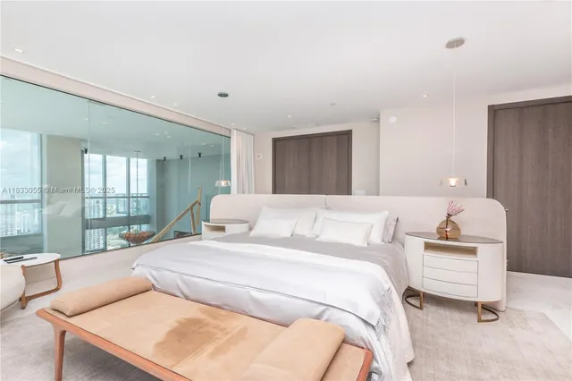 a bedroom with a bed and a large window