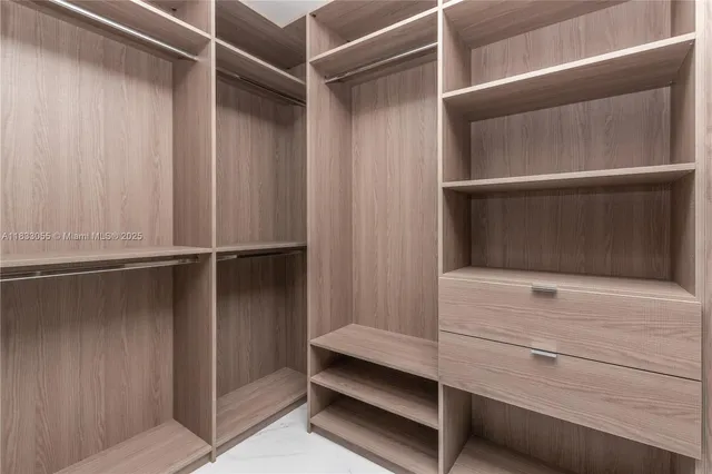 a bathroom with a double vanity sink mirror and bathtub