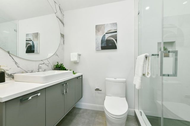 a bathroom with a toilet sink and mirror
