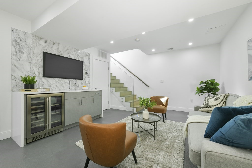 63 Alpine Street, Unit 1 Cambridge, MA 02138 - Photo 17 of 27 a living room with furniture and a flat screen tv