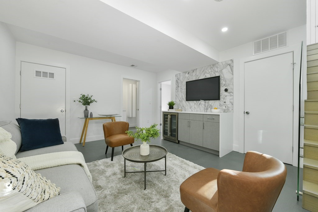 63 Alpine Street, Unit 1 Cambridge, MA 02138 - Photo 18 of 27 a living room with furniture and a flat screen tv