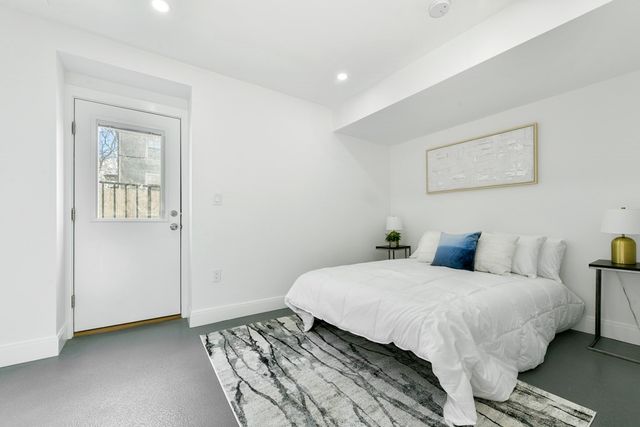 a bedroom with a bed and a painting