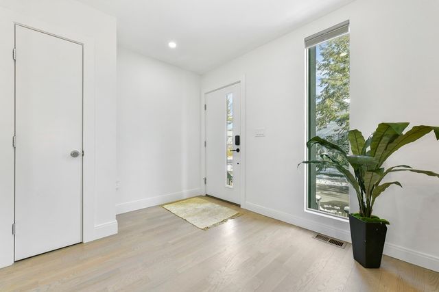 an empty room with windows and flower pot