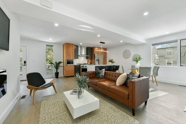a living room with furniture a rug and a large window