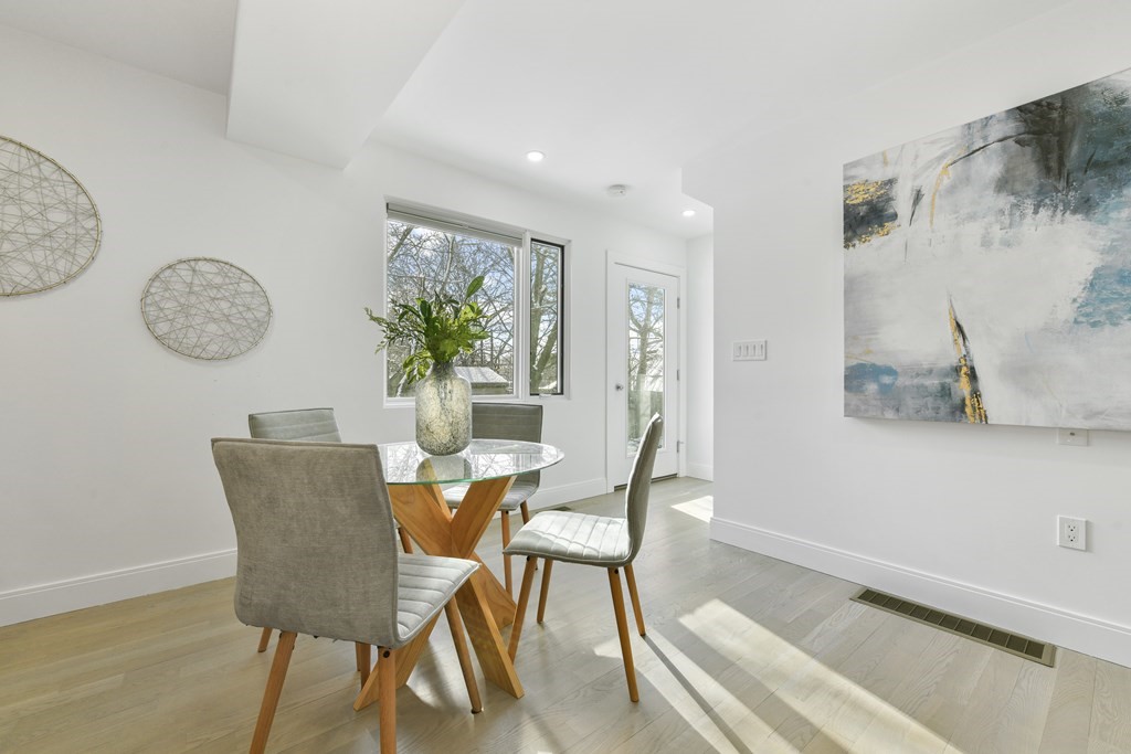 63 Alpine Street, Unit 1 Cambridge, MA 02138 - Photo 6 of 27 a view of a dining room with furniture and wooden floor
