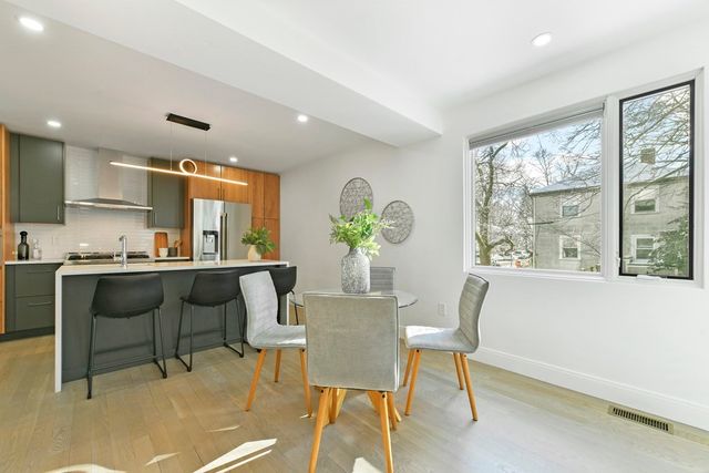 a view of a dining room with furniture and a potted plant