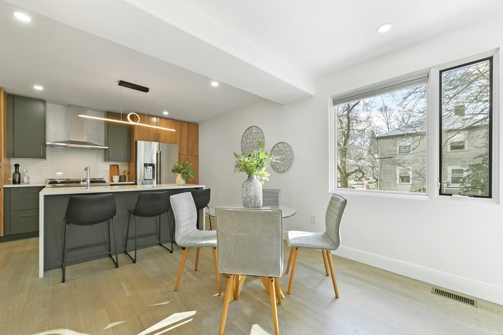 63 Alpine Street, Unit 1 Cambridge, MA 02138 - Photo 7 of 27 a view of a dining room with furniture and a potted plant