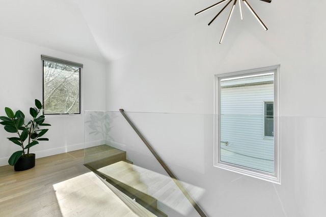 a view of entryway and hall with wooden floor