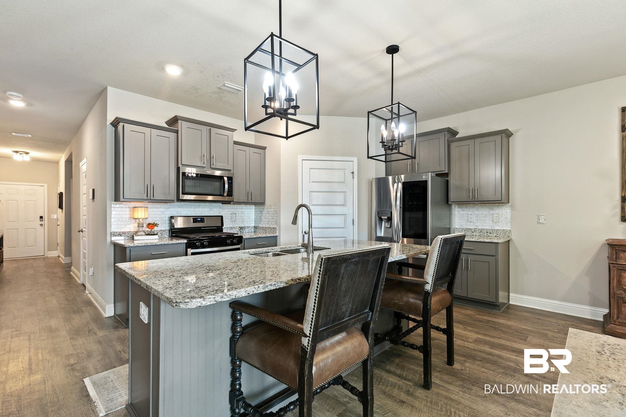 31650 Memphis Loop Daphne, AL 36527 - Photo 9 of 68 Kitchen featuring backsplash, stainless steel appliances, gray cabinets, and light stone counters