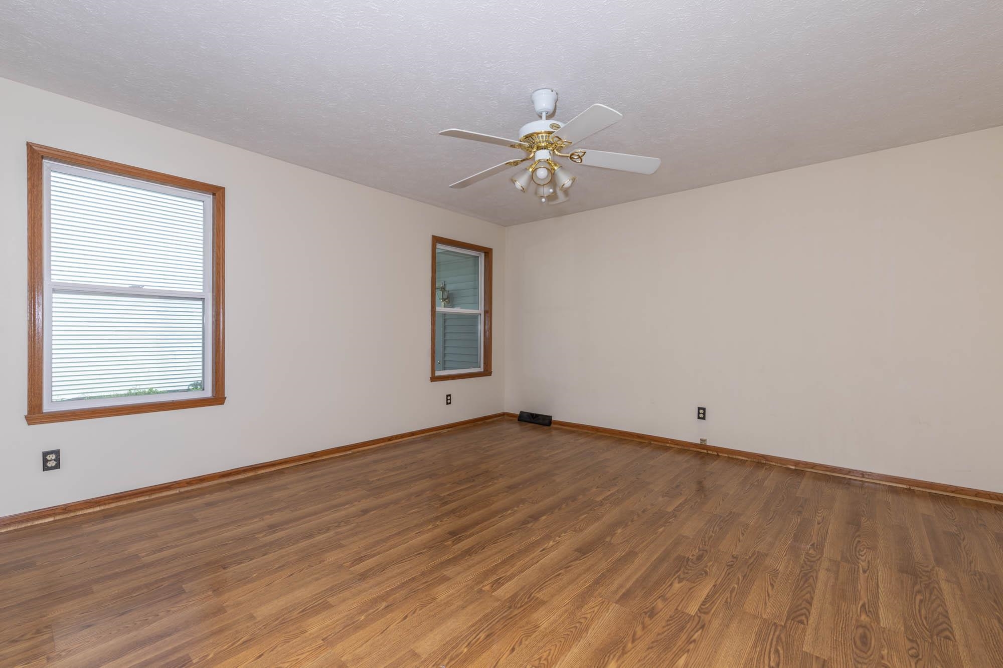 10686 Meadowsweet Lane Roscoe, IL 61073 - Photo 16 of 33 a view of an empty room with a window and wooden floor