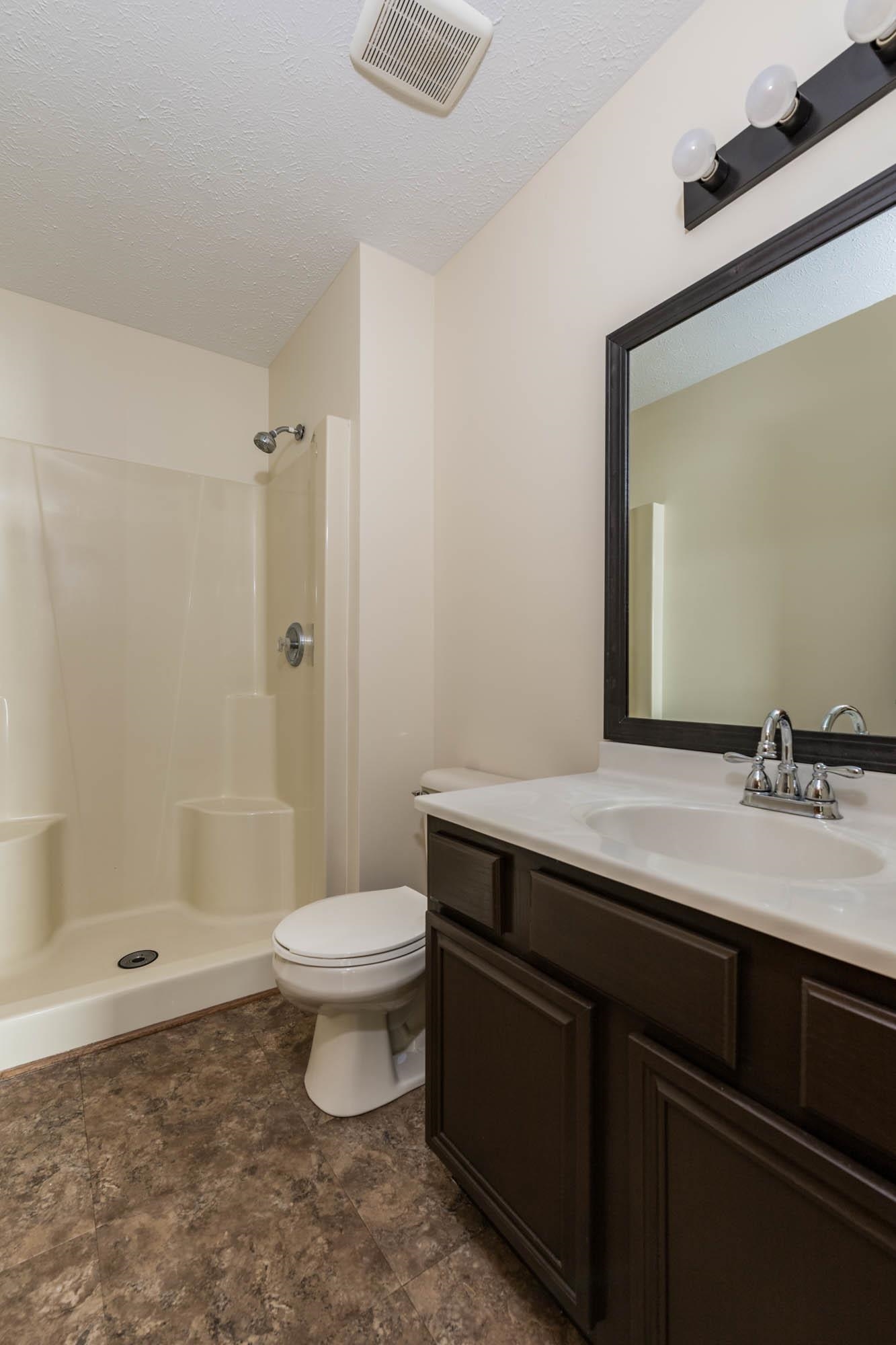 10686 Meadowsweet Lane Roscoe, IL 61073 - Photo 17 of 33 a bathroom with a sink a toilet and shower