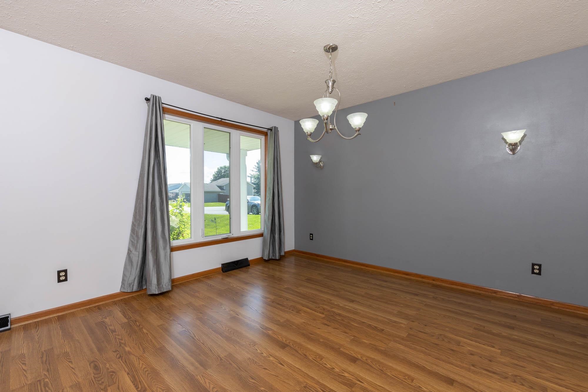 10686 Meadowsweet Lane Roscoe, IL 61073 - Photo 7 of 33 an empty room with wooden floor and windows