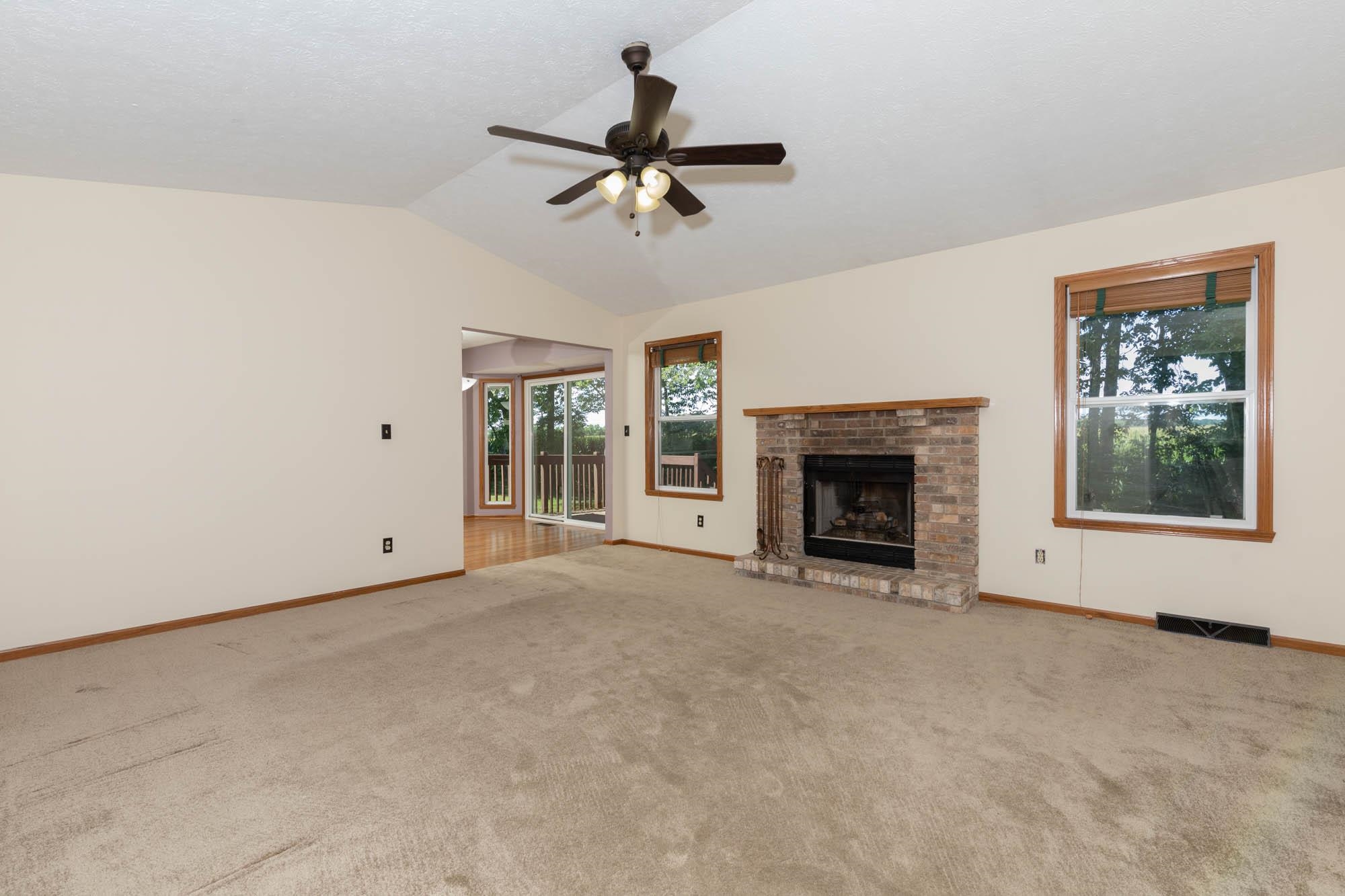 10686 Meadowsweet Lane Roscoe, IL 61073 - Photo 8 of 33 a view of a livingroom with a fireplace and window