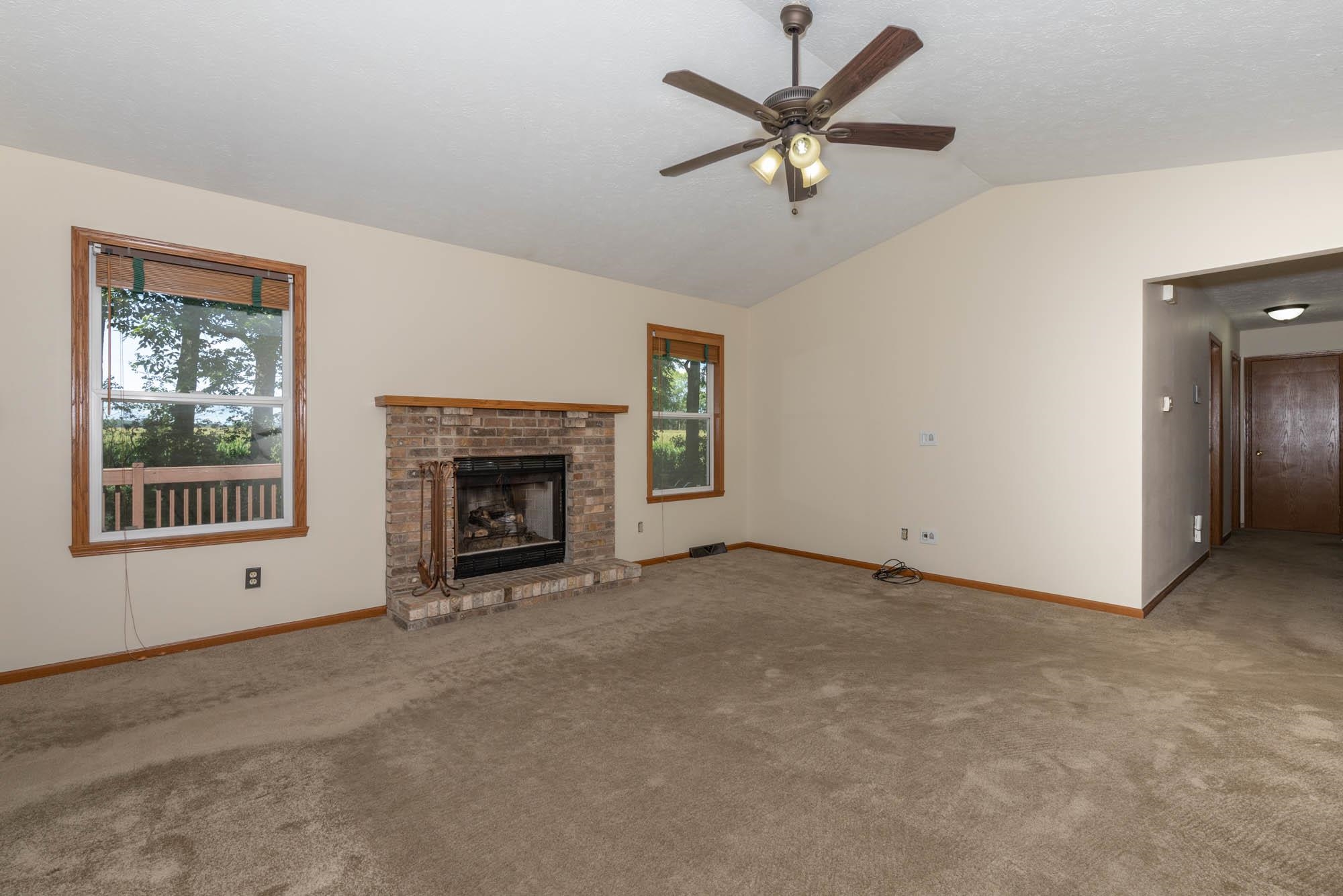 10686 Meadowsweet Lane Roscoe, IL 61073 - Photo 9 of 33 an empty room with windows and fireplace