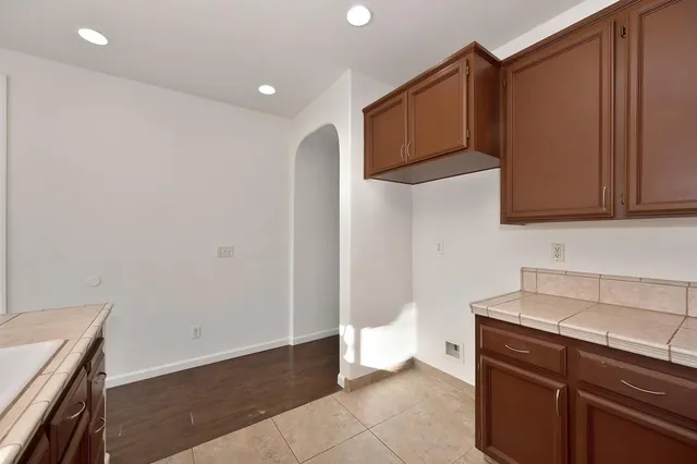 a view of a storage and utility room with wooden floor