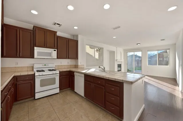 a kitchen with a sink stove and cabinets