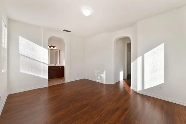 wooden floor in an empty room with a window