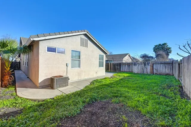 a view of a house with backyard and sitting area