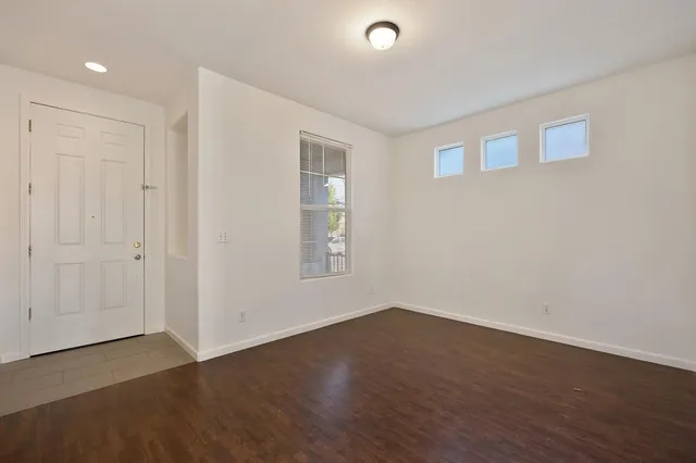 a view of a room with wooden floor and windows