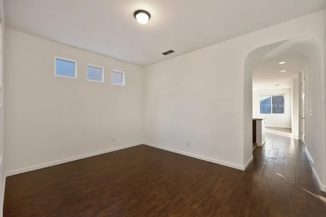 a view of a room with wooden floor and a bathroom