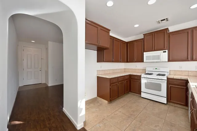 a kitchen with a stove top oven sink and cabinets