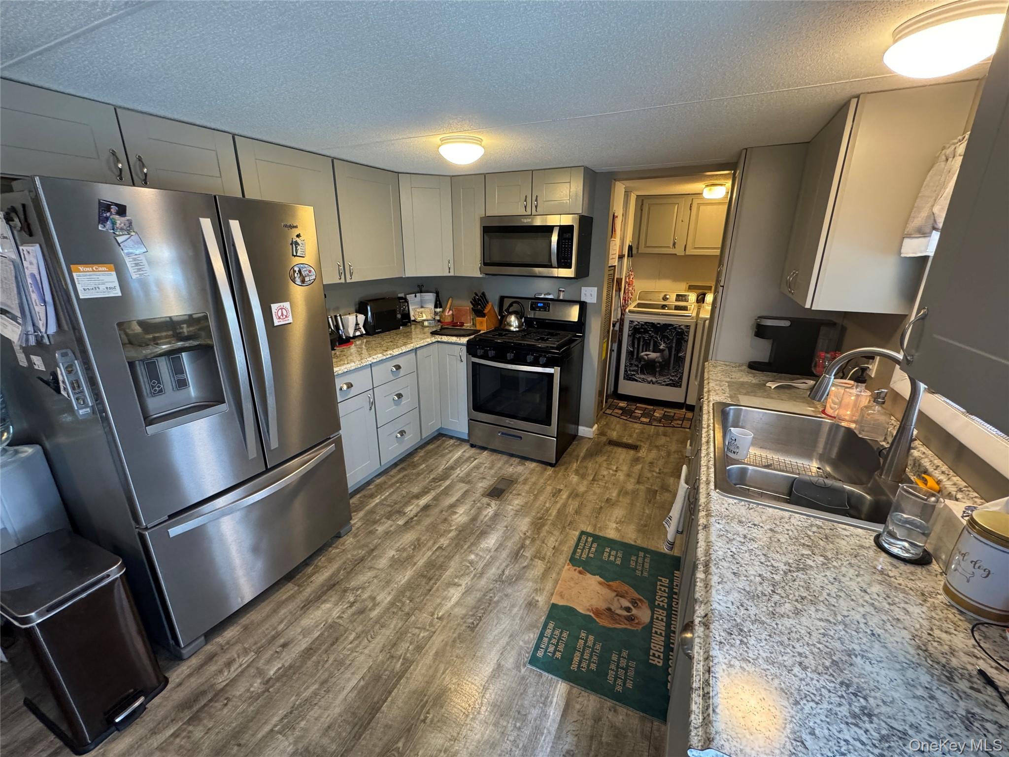 42 Fittkau Road Swan Lake, NY 12783 - Photo 13 of 36 a kitchen with granite countertop a refrigerator stove and wooden floor
