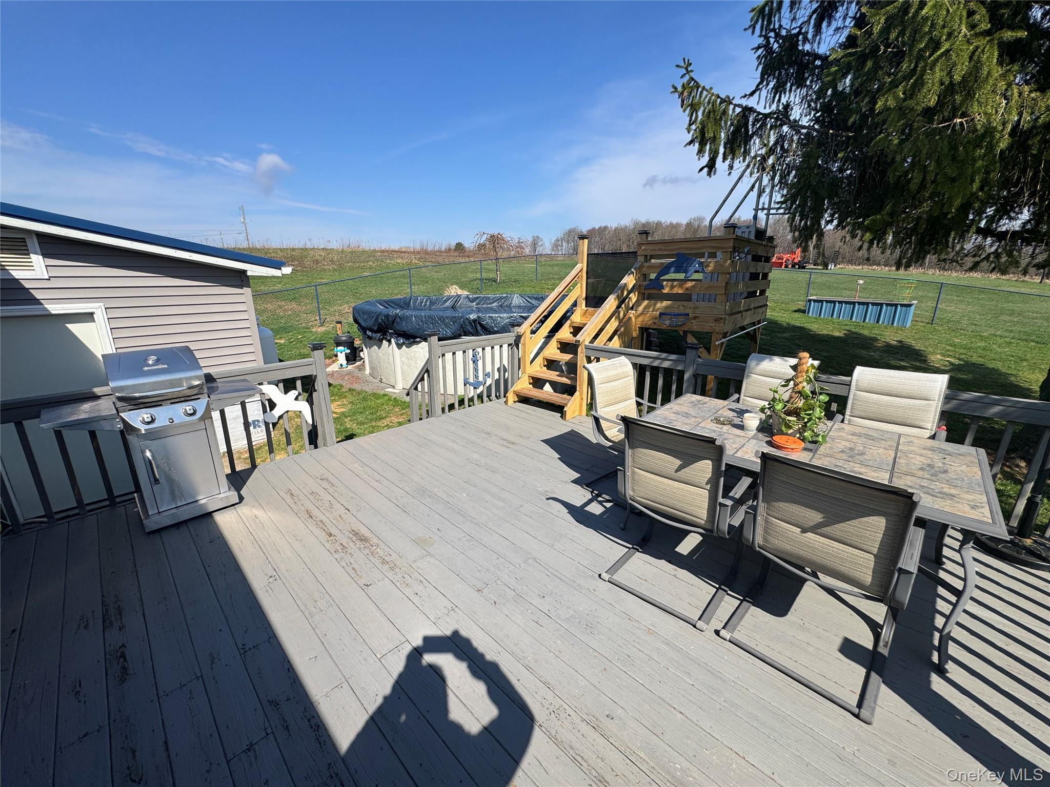 42 Fittkau Road Swan Lake, NY 12783 - Photo 15 of 36 a view of a patio with lawn chairs floor to ceiling window and wooden floor
