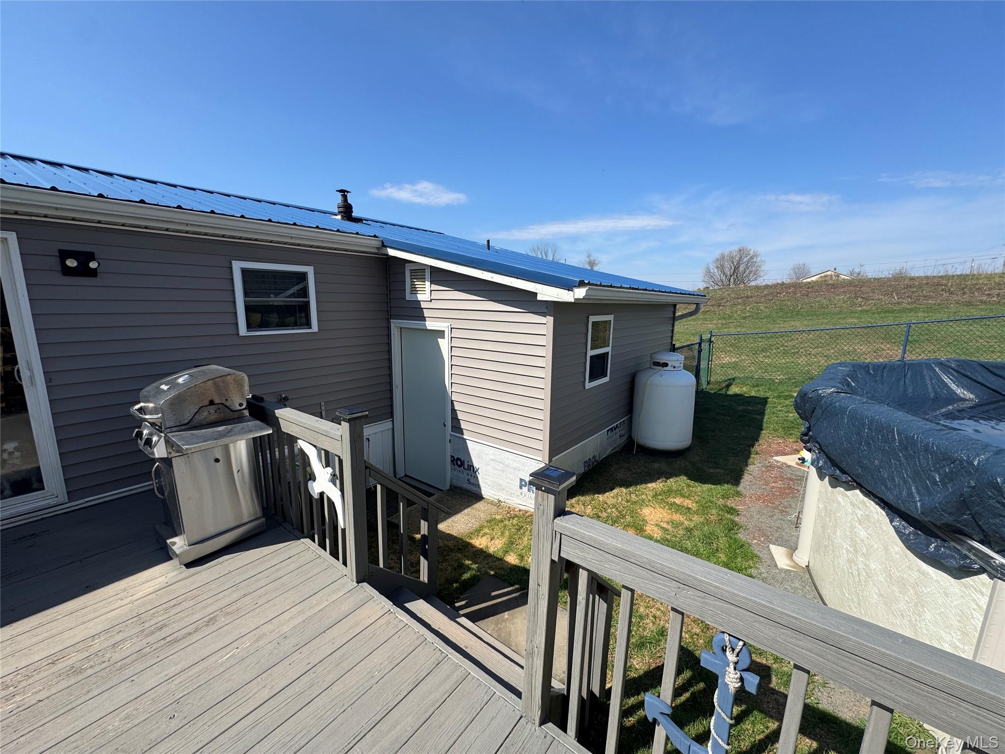 42 Fittkau Road Swan Lake, NY 12783 - Photo 16 of 36 a view of a balcony with chairs and wooden floor