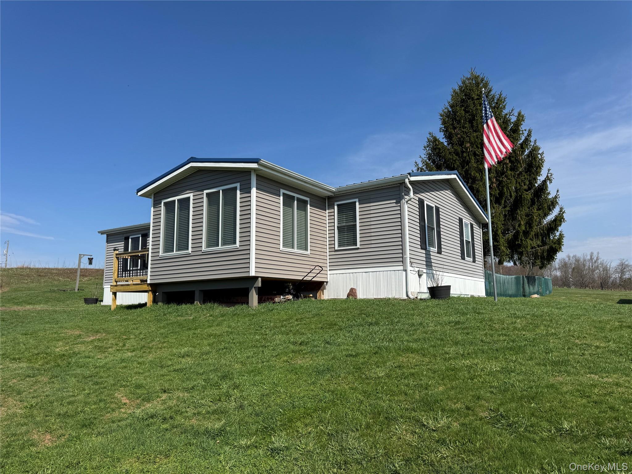 42 Fittkau Road Swan Lake, NY 12783 - Photo 2 of 36 a front view of a house with a yard