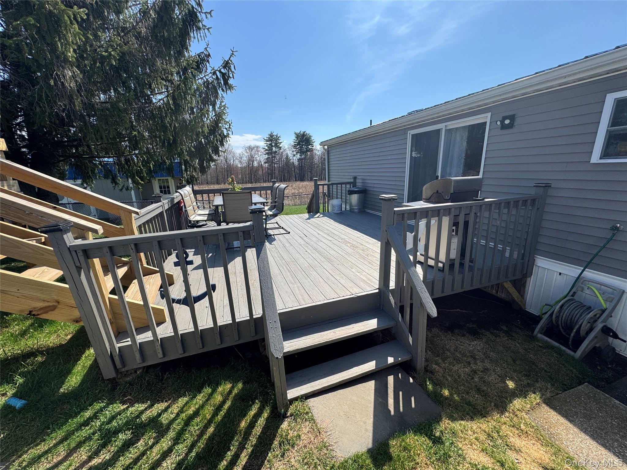 42 Fittkau Road Swan Lake, NY 12783 - Photo 34 of 36 a view of a roof deck with wooden floor and fence