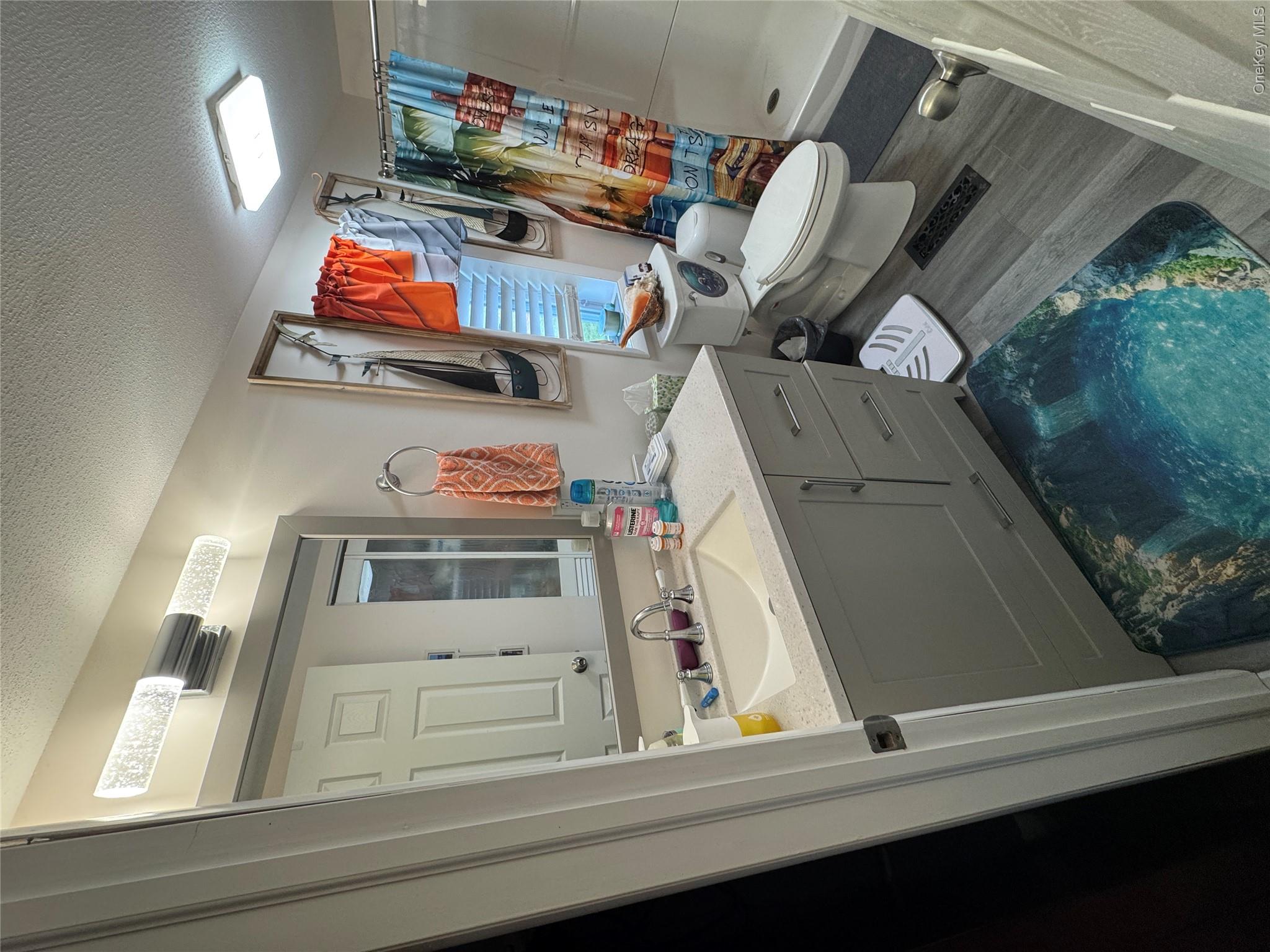 42 Fittkau Road Swan Lake, NY 12783 - Photo 7 of 36 a bathroom with a sink mirror vanity and toilet