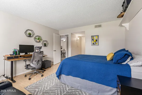 a bedroom with a bed and a flat screen tv