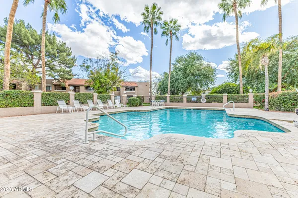 a view of a swimming pool with a lounge chairs