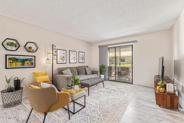 a living room with furniture and wooden floor