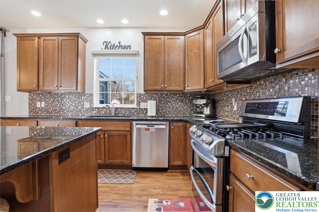 628 South 4th Street Bangor, PA 18013 - Photo 30 of 97 a kitchen with stainless steel appliances granite countertop a stove a sink and a microwave