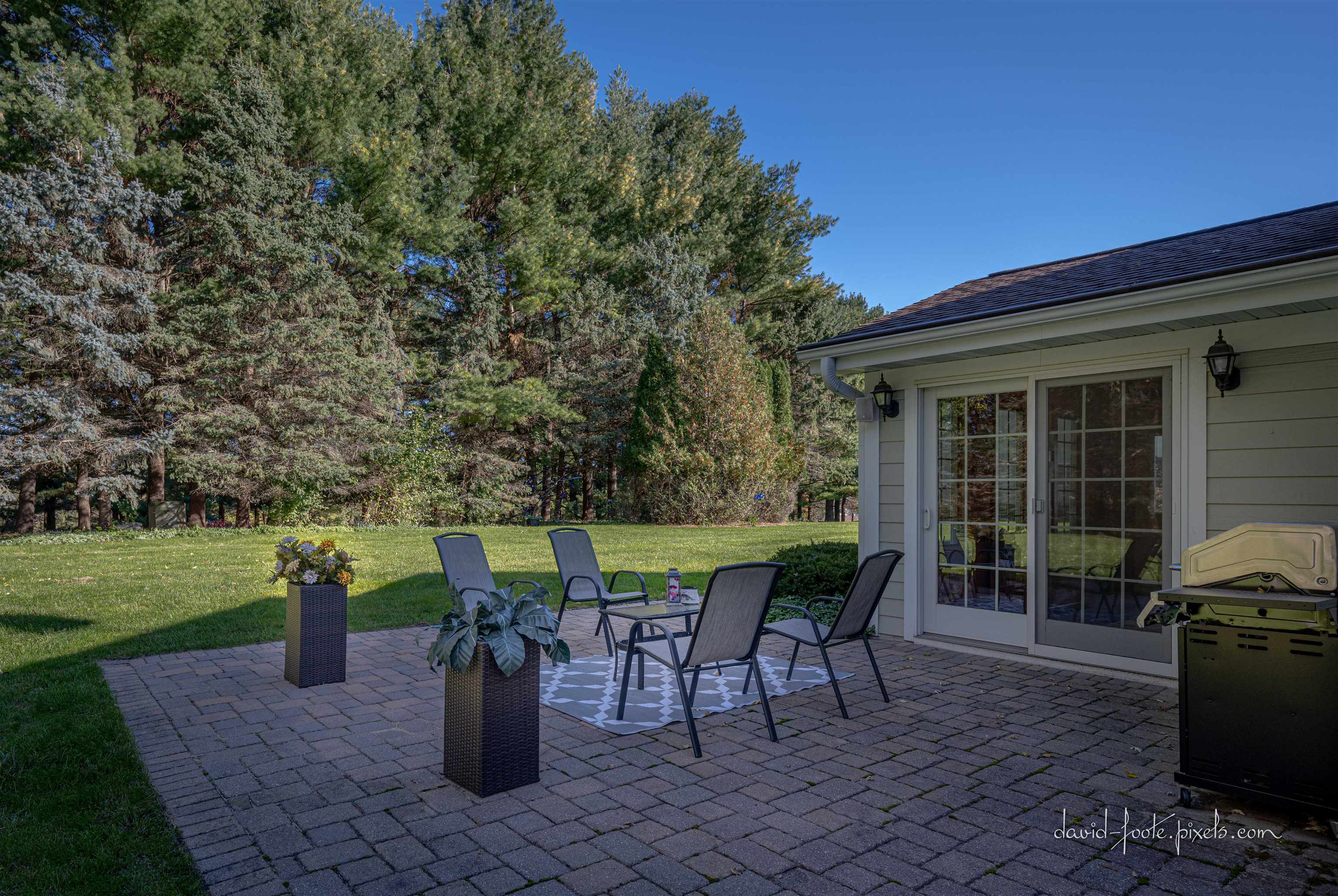 8936 North Cedarville Road Lena, IL 61048 - Photo 32 of 51 a view of a patio with table and chairs potted plants with wooden fence