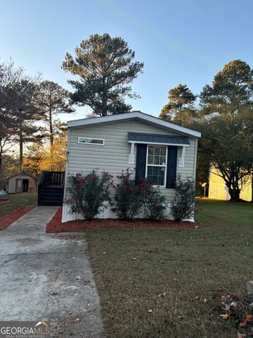 a view of a house with a yard and a garden