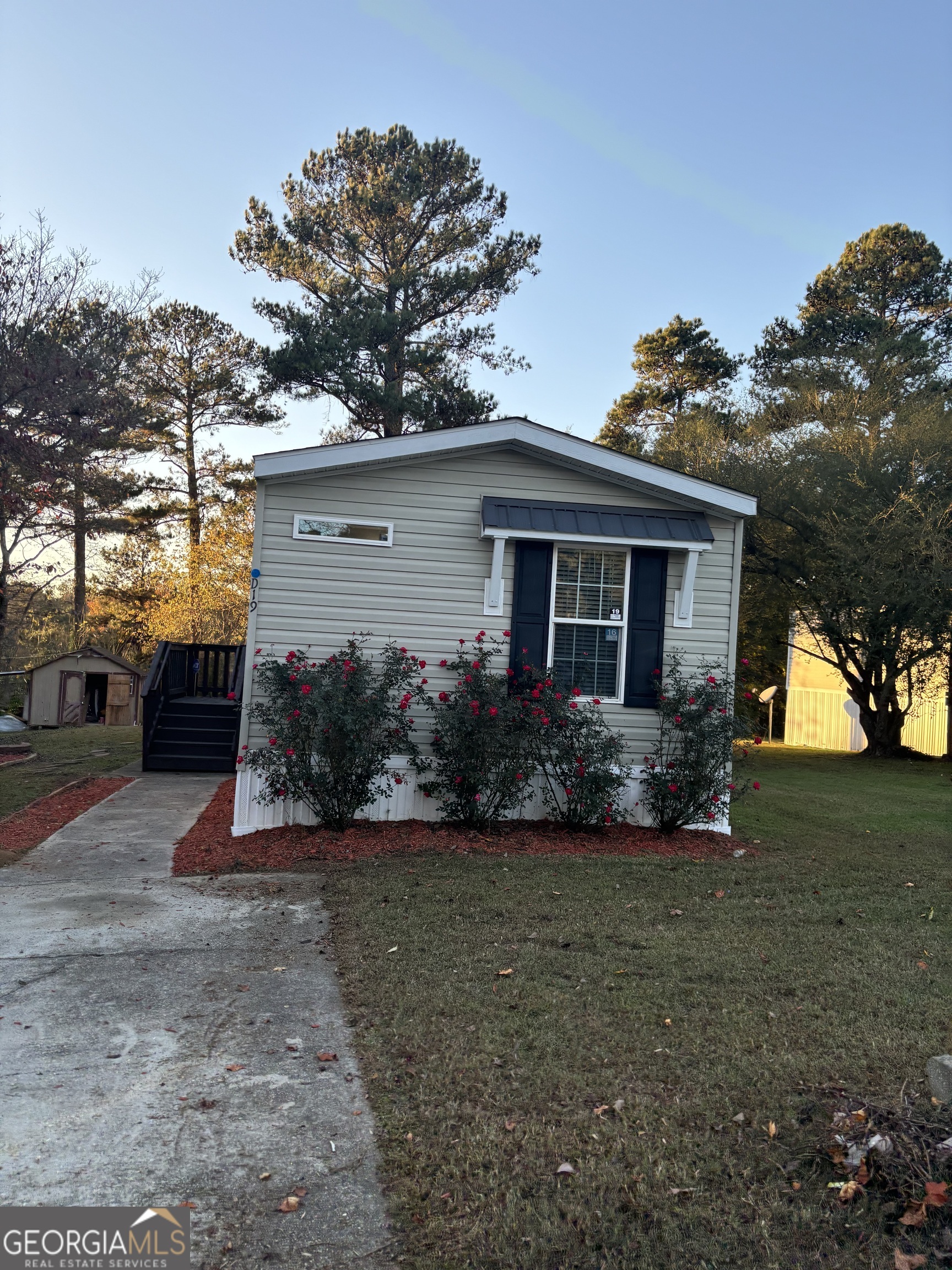 4255 Smokecreek Court Southwest, Unit 1 Snellville, GA 30039 - Photo 1 of 6 a view of a house with a yard and a garden