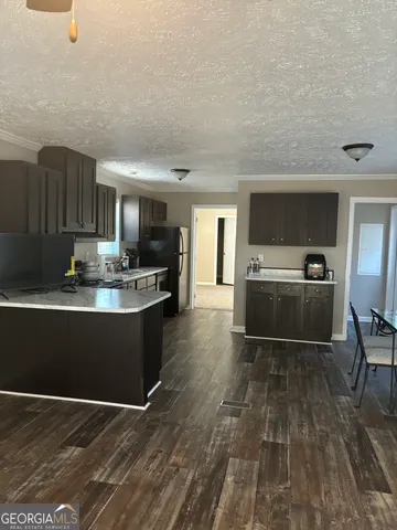 a view of kitchen with sink microwave and cabinets