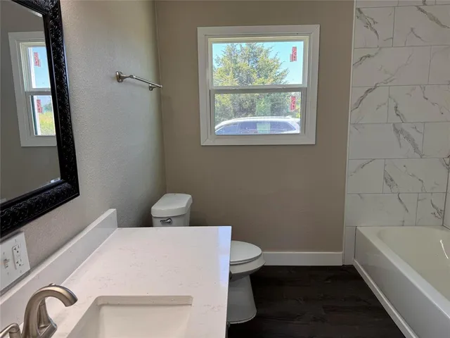 a bathroom with a toilet and a bathtub