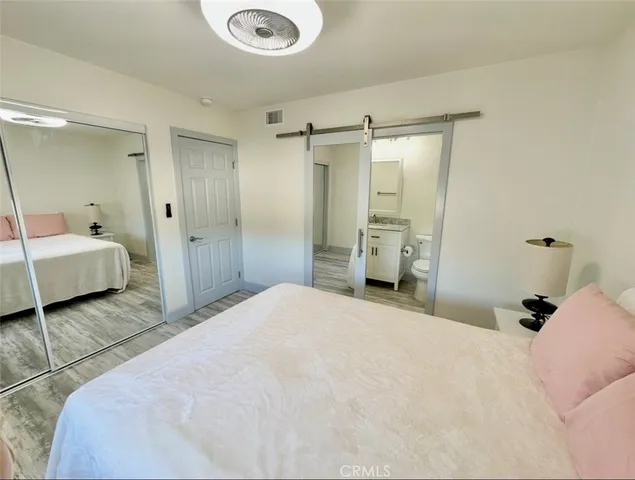 a bedroom with a bed and closet