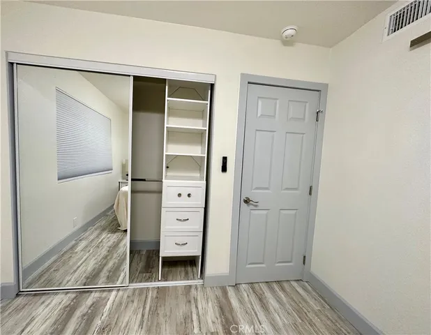 wooden floor and closet in a bathroom