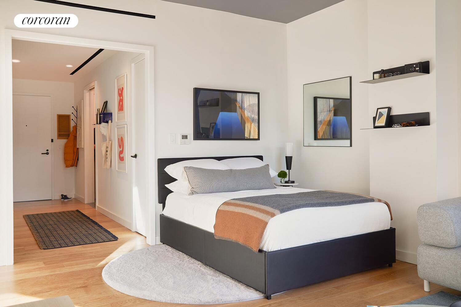 547 West 47th Street, Unit 313 Manhattan, NY 10036 - Photo 3 of 30 a bedroom with bed and a couch