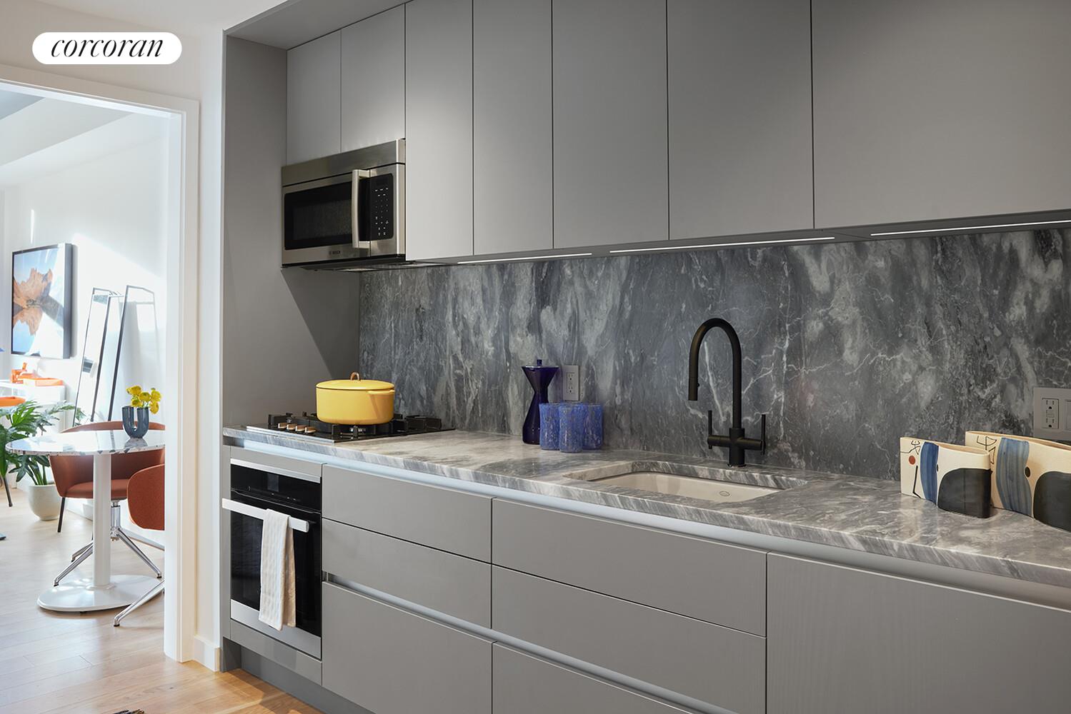 547 West 47th Street, Unit 313 Manhattan, NY 10036 - Photo 5 of 30 a kitchen with a sink and a stove top oven