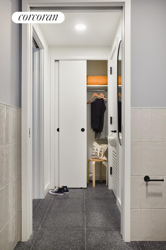 547 West 47th Street, Unit 313 Manhattan, NY 10036 - Photo 7 of 30 a view of a hallway with washer and dryer